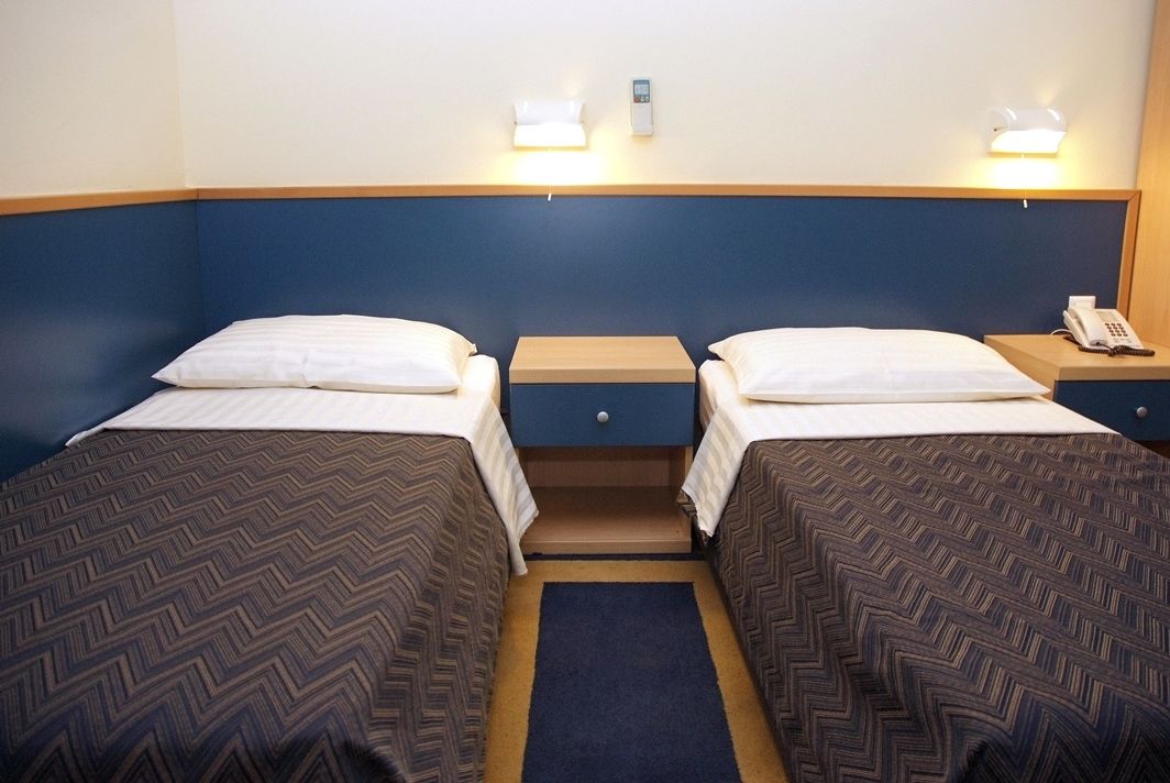 Twin room with two separate beds and nightstand